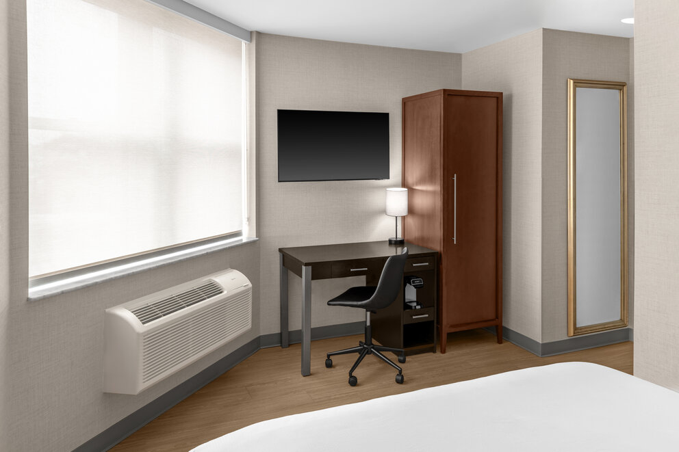 a room with a desk and a television