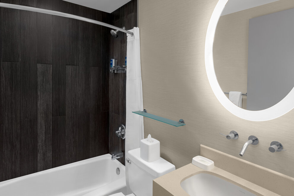 a bathroom with a round mirror