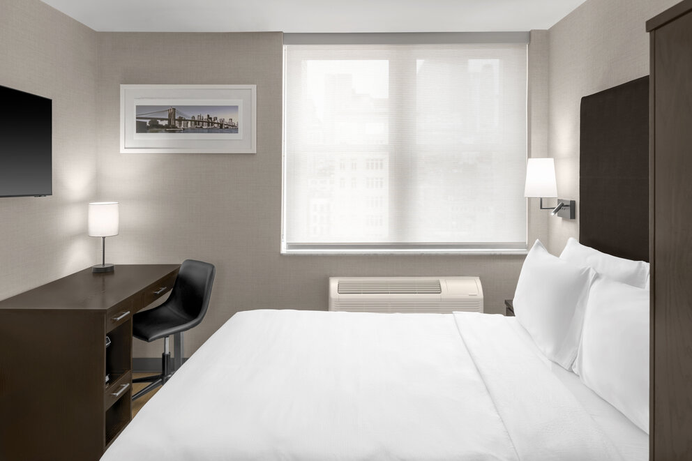 a room with a bed and a desk