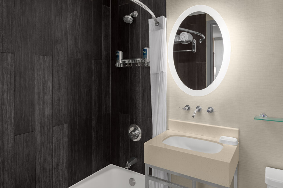 a bathroom with a shower and a mirror