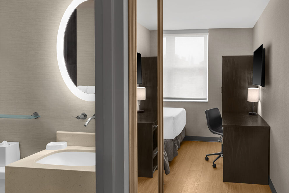 a room with a mirror and a sink