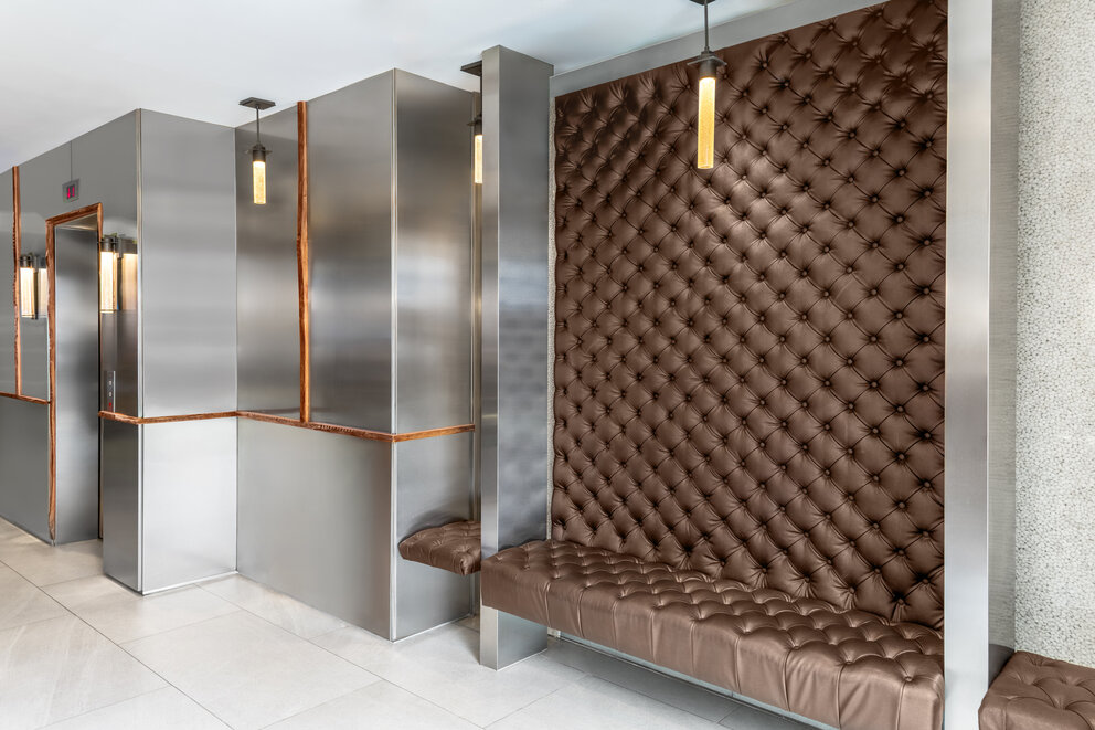a brown leather bench in a room