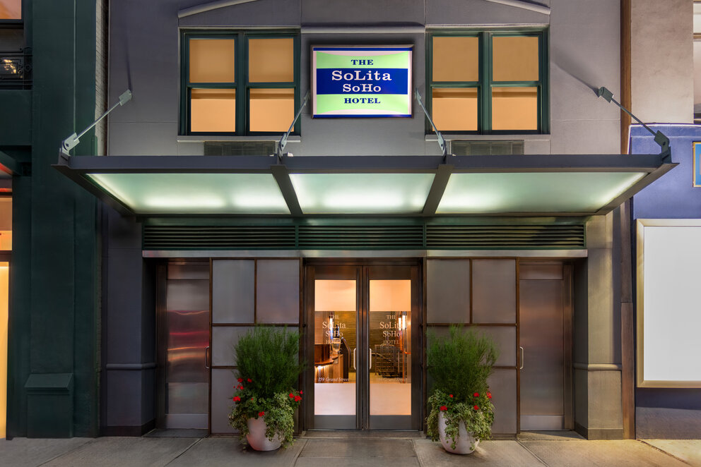 a building with glass doors and a sign